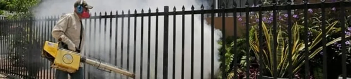 Mosquito control technician fogging a yard perimeter for mosquito reduction in Chula Vista, CA